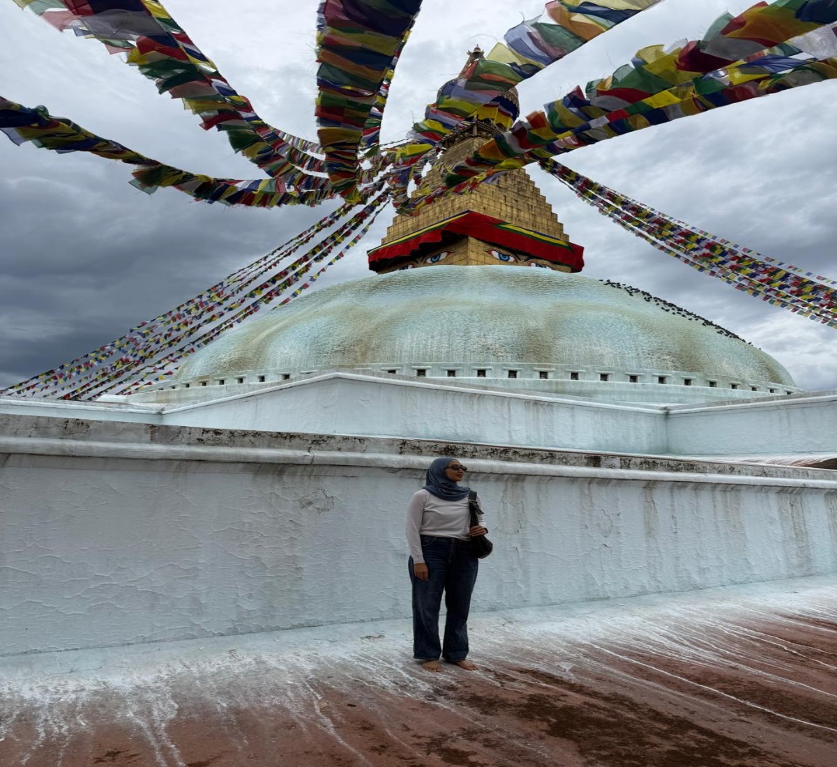 A happy pilgrim inside the main complex of Bouddhanath Stupa