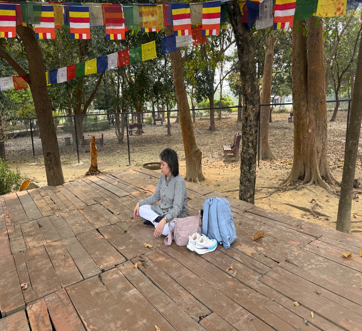 ​​​​​​An older pilgrim meditating at Ramagram stupa site during a Buddhist pilgrimage tour